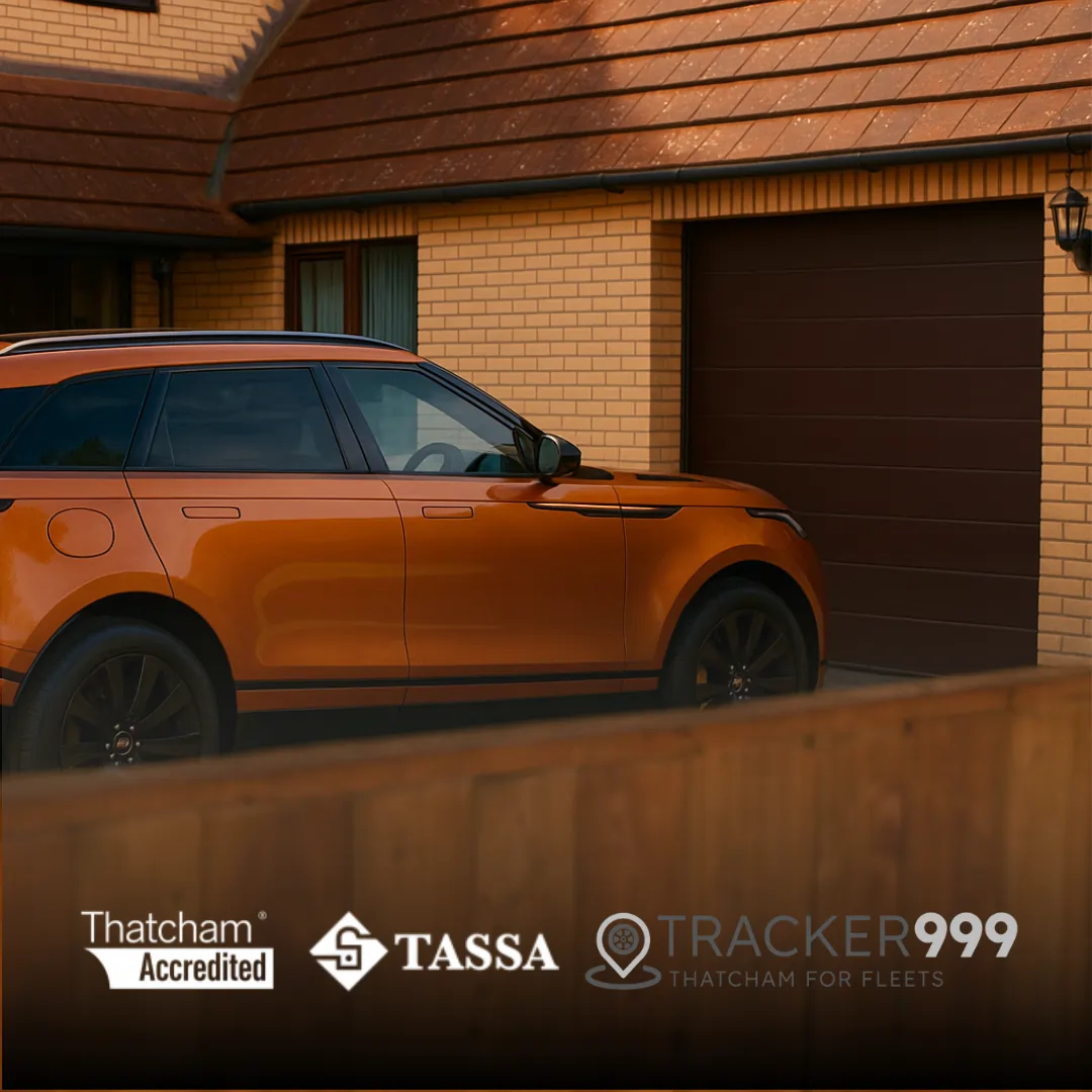 Luxury SUV parked outside home with Thatcham, TASSA, and Tracker999 logos displayed, promoting vehicle tracker security.