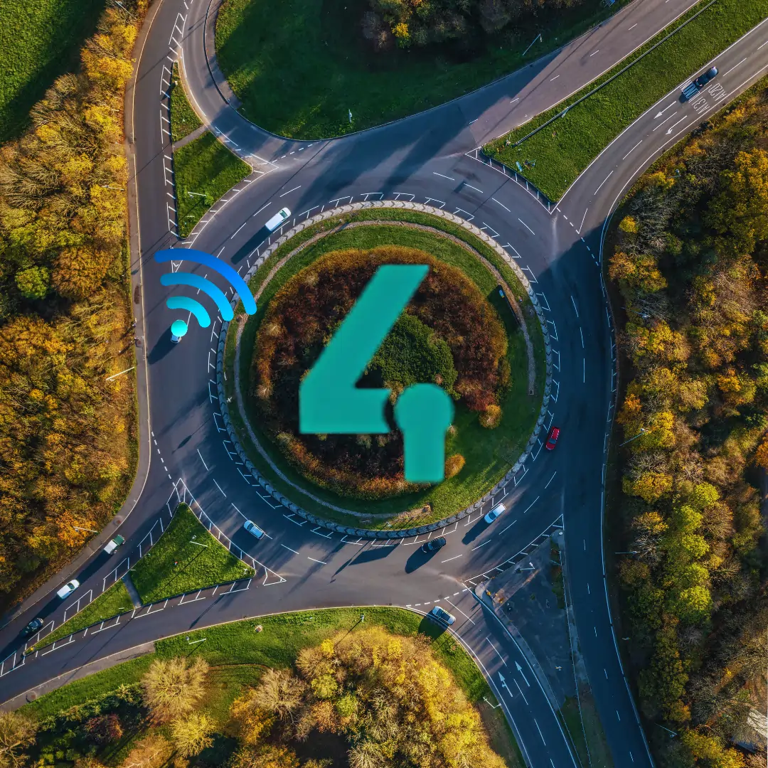 Aerial view of a roundabout with an icon representing a vehicle tracker and wireless immobilisation technology overlayed, symbolising remote vehicle security.